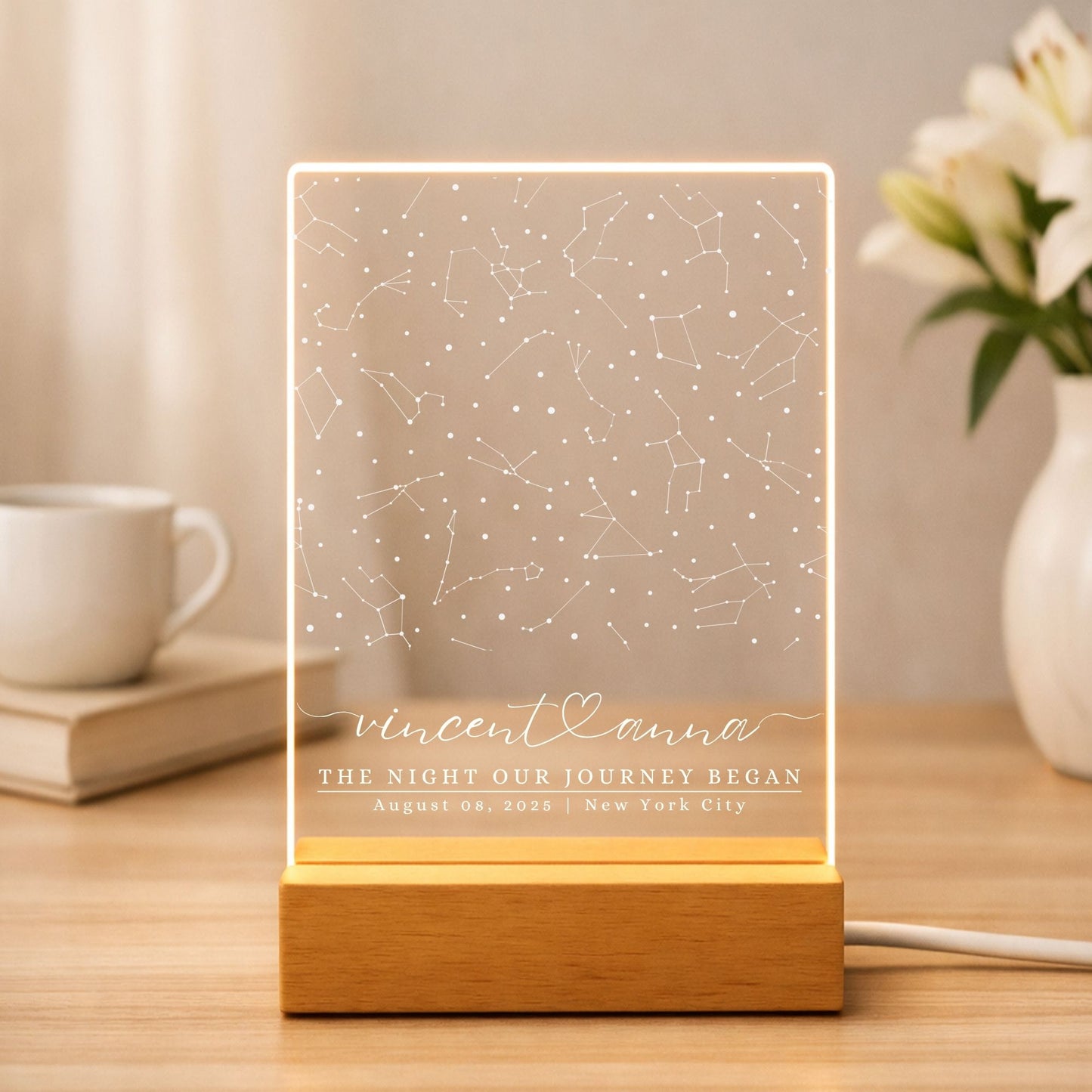 Soft gold LED light refracting through a personalized acrylic star map in a modern living room.