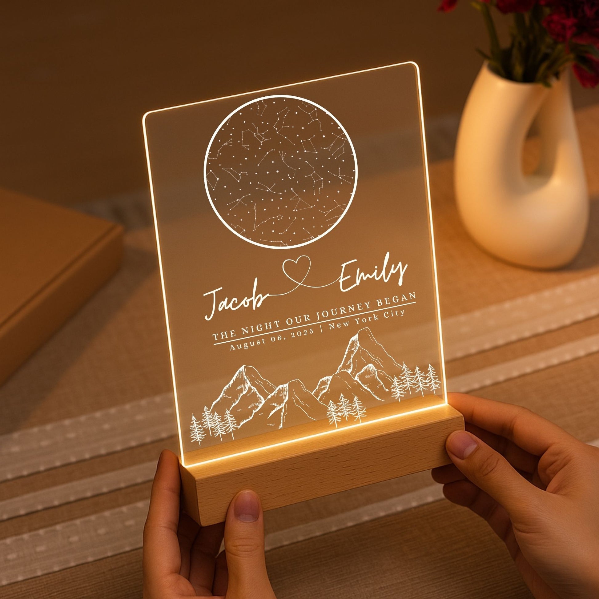a hand holding the star map light from the night the journey began