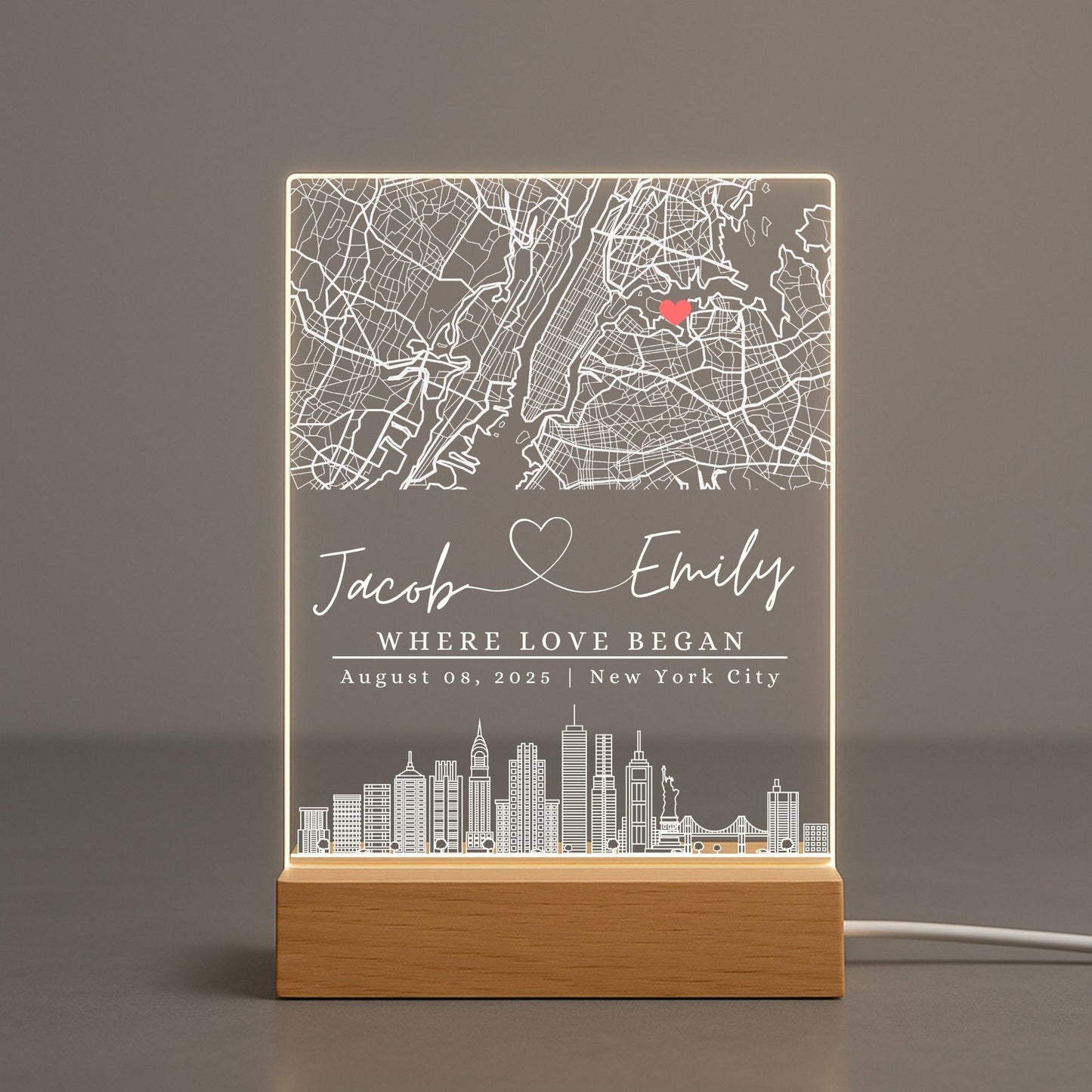 Soft warm glow of a personalized map light casting shadows on a neutral-toned wall.