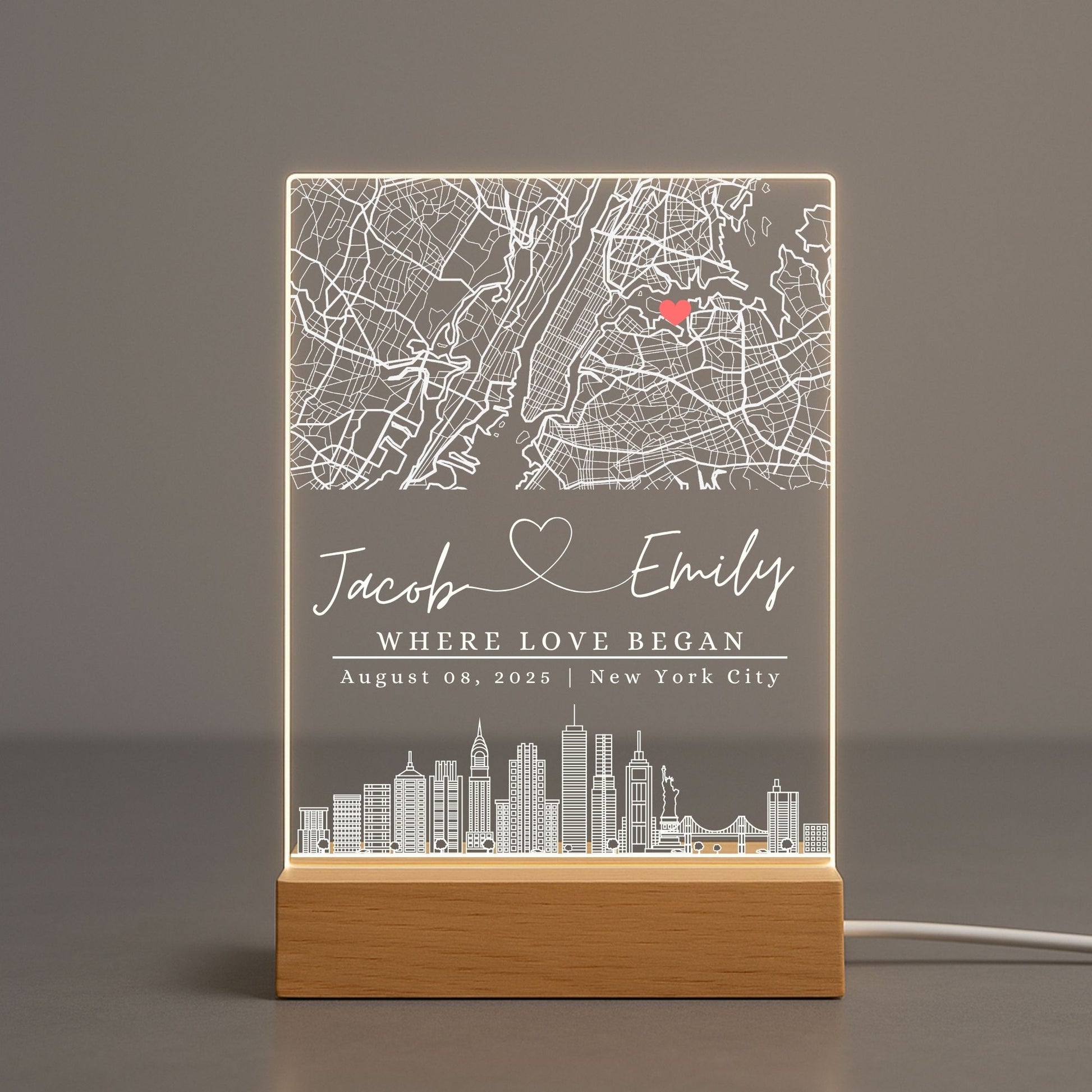 Soft warm glow of a personalized map light casting shadows on a neutral-toned wall.