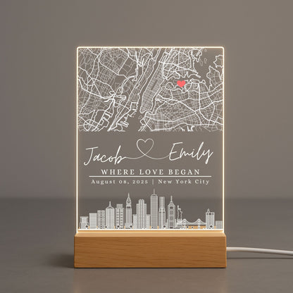 Soft warm glow of a personalized map light casting shadows on a neutral-toned wall.