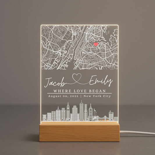 Soft warm glow of a personalized map light casting shadows on a neutral-toned wall.