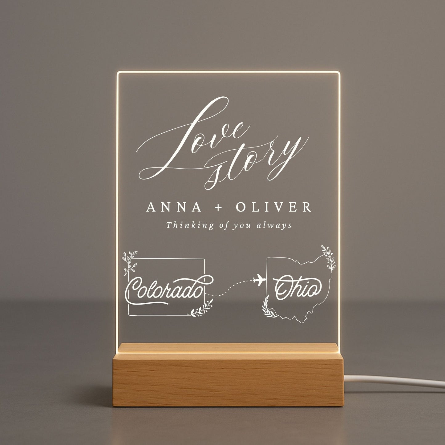 Acrylic light displaying two personalized state shapes and a couple's names.