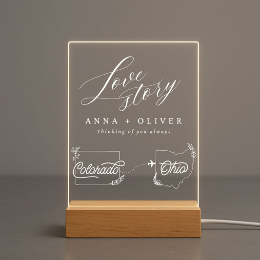 Acrylic light displaying two personalized state shapes and a couple's names.