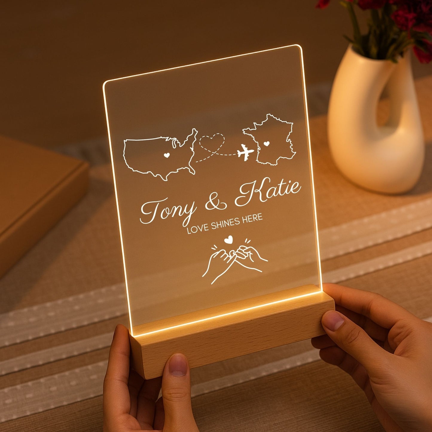 Handheld view of a personalized long-distance lamp showing its compact, portable size.