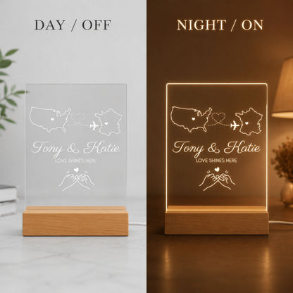 Day and night split display of country-to-country acrylic night light showing engraved line art unlit in daylight and glowing warm LED light at night.