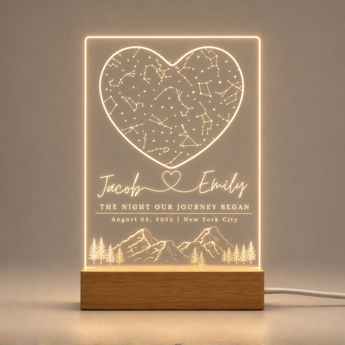Studio front view of illuminated heart constellation star map acrylic lamp glowing warm white on a natural wooden LED base.