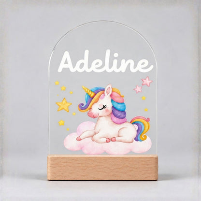 Unlit baby unicorn night light on a plain background, showing the custom name, colorful artwork and wooden base.