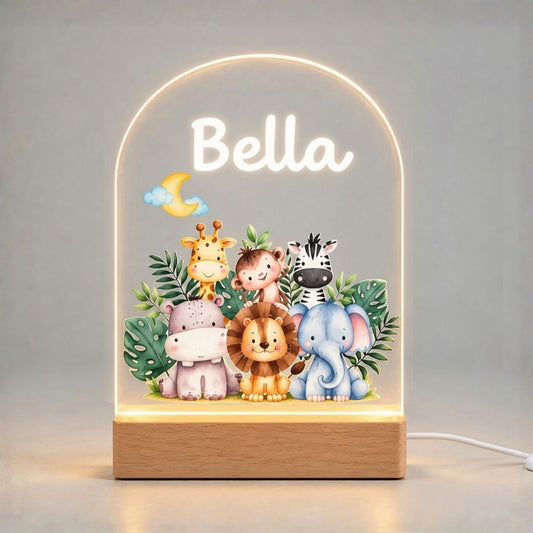 Illuminated baby safari animal acrylic night light on a plain light background, with a personalized name above the artwork and a wooden base.