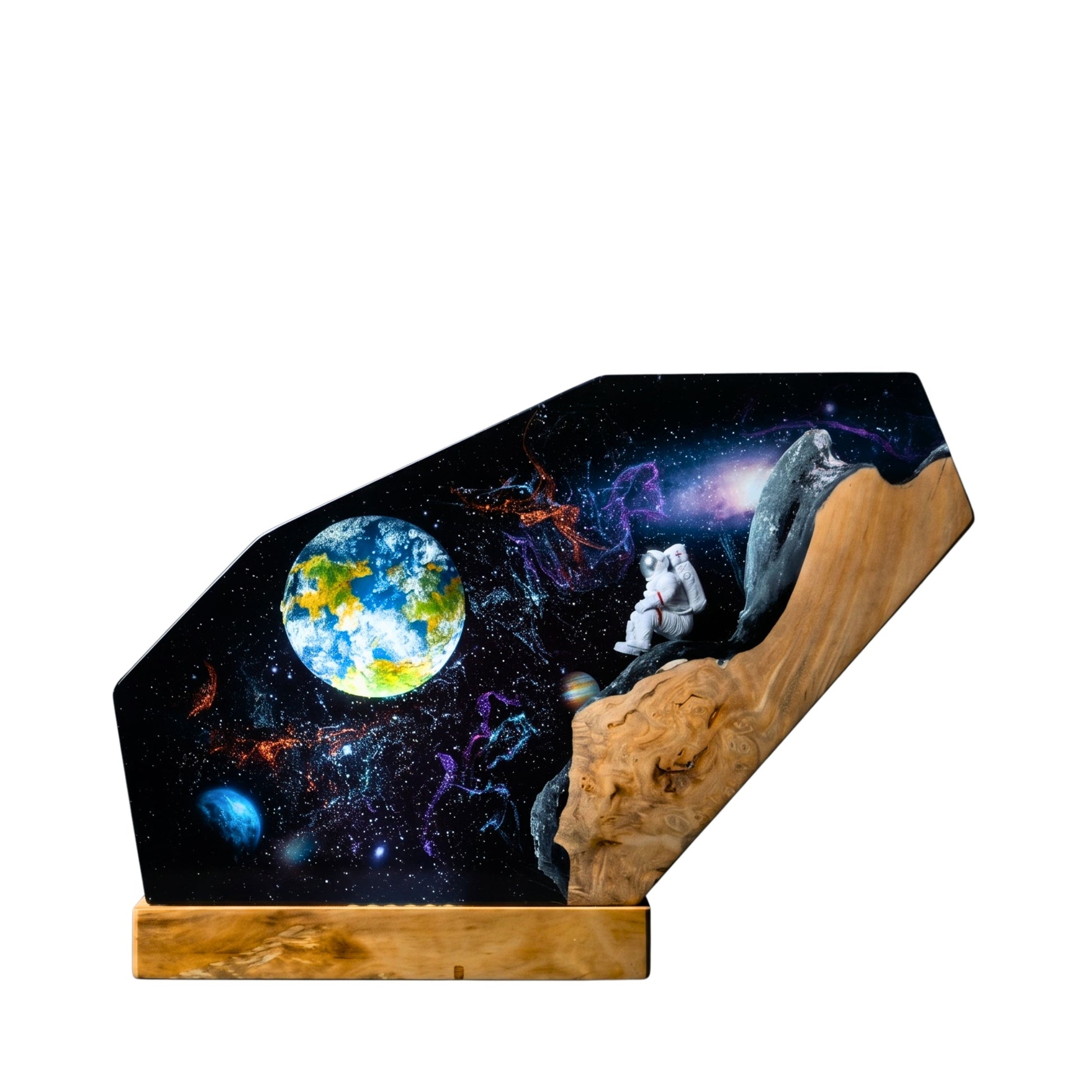 Handcrafted astronaut galaxy epoxy resin night light on a wooden base isolated on a clean white background, showcasing an intricate outer space scene with a miniature astronaut sitting on a wooden cliff.