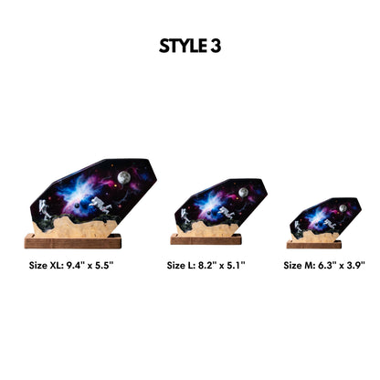 Size chart for astronaut galaxy epoxy resin lamp showcasing three available dimensions: Medium (6.3 by 3.9 inches), Large (8.2 by 5.1 inches), and Extra Large (9.4 by 5.5 inches)