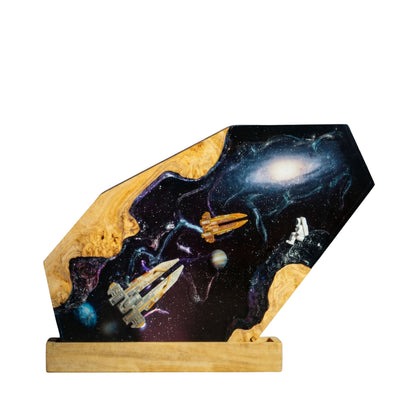 Handcrafted sci-fi spaceship epoxy resin night light on a wooden base isolated on a white background, featuring miniature spaceships and a floating astronaut navigating a cosmic galaxy with planets and a glowing spiral nebula.