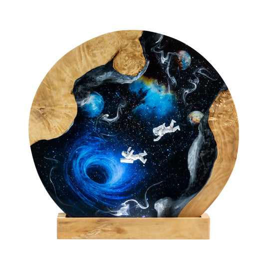 Decorative astronaut galaxy resin lamp with space-themed design on a wooden base