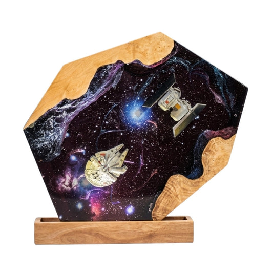Galaxy resin epoxy lamp with embedded spaceship models on live-edge burl wood stand, white background