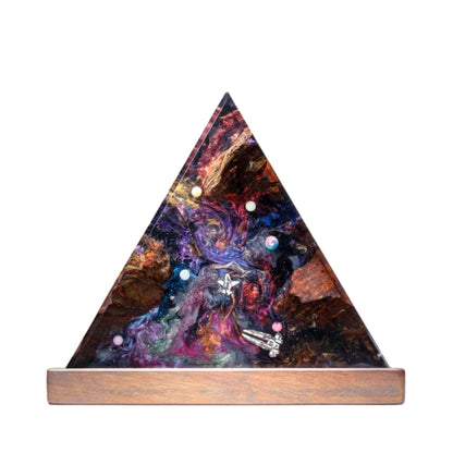 Handmade triangular resin lamp featuring a vivid red and blue galaxy design with an astronaut figure and a solid wood base, isolated on a white background.