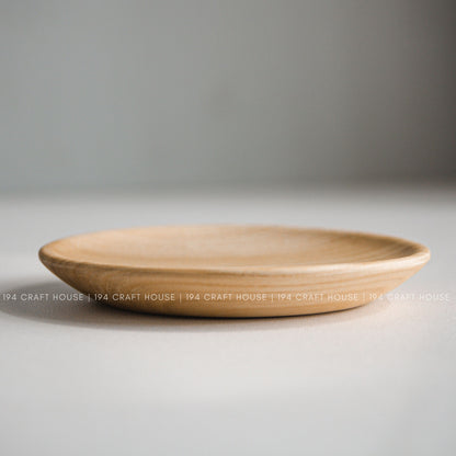 Low side view showing the shallow shape and rounded rim of a wood plate