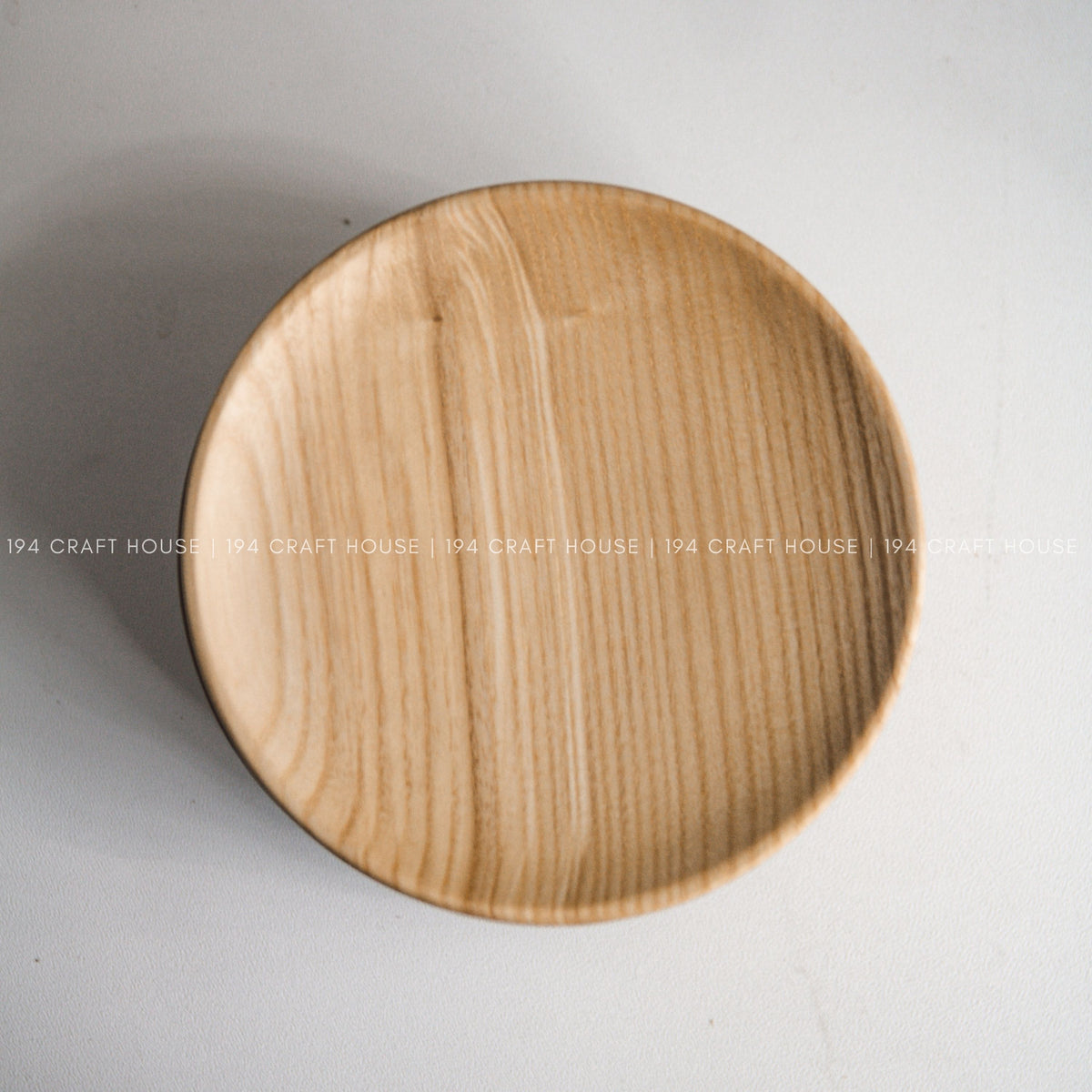 Overhead close view of the wood grain and rounded outline of the plate