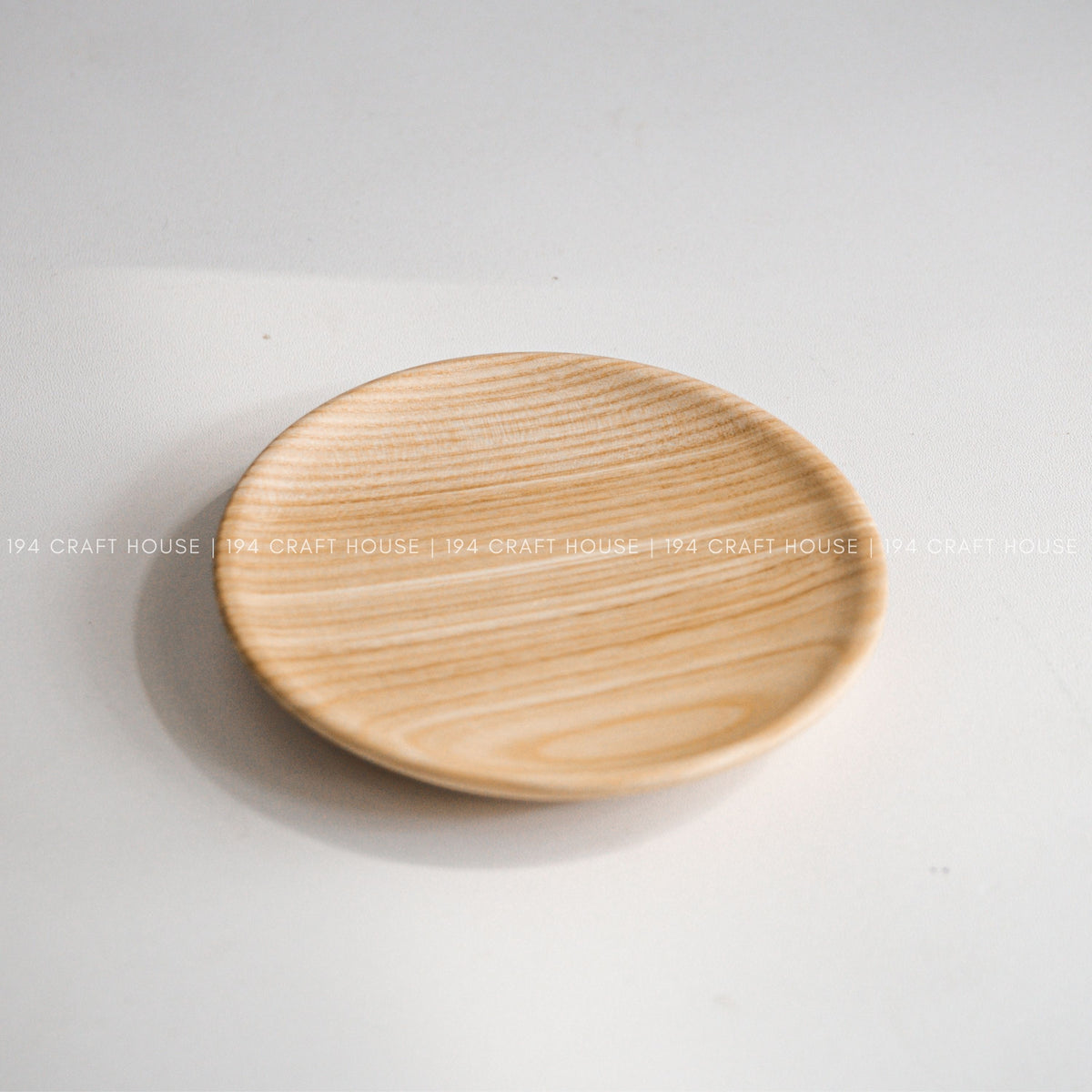 Round wood plate viewed from above on a light background