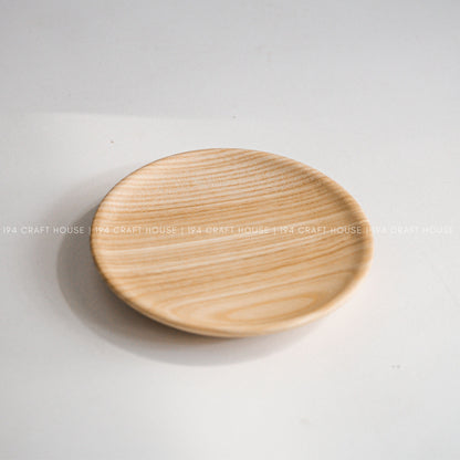 Round wood plate viewed from above on a light background