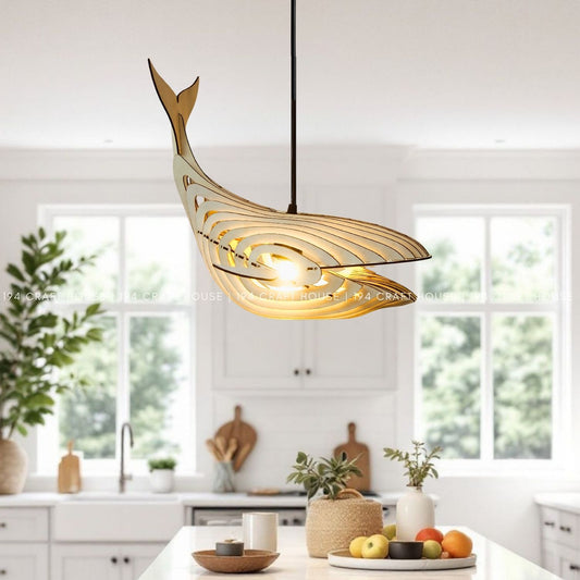 Illuminated whale-shaped pendant light hanging above a bright kitchen island
