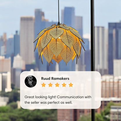 Front view of lit Bodhi leaf pendant lamp centered on a plain white background