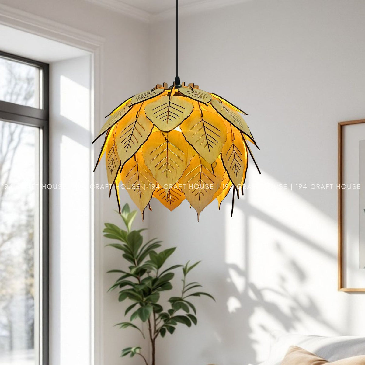Lit bodhi leaf wood pendant hanging in bright living room near window and plant