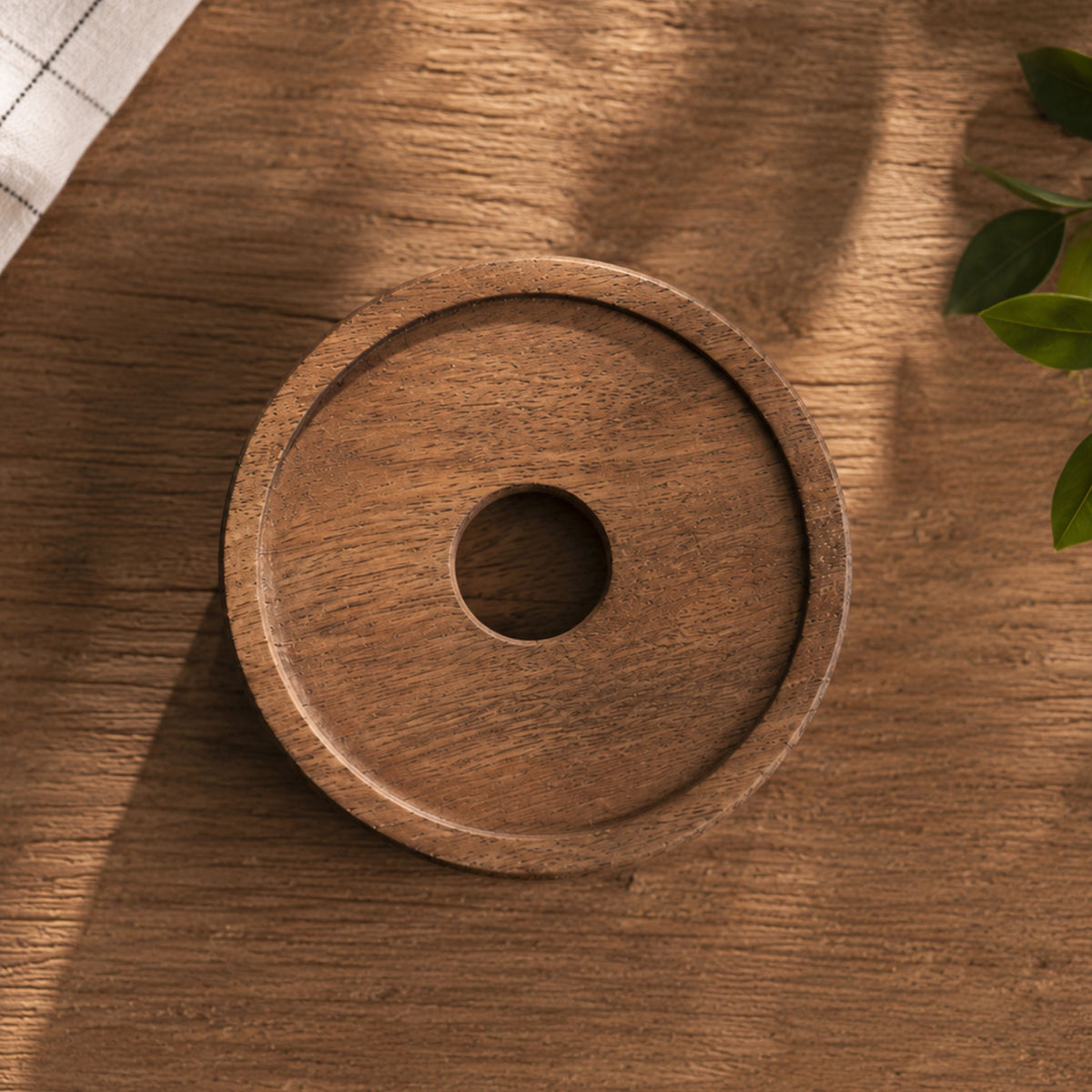 Top-down view of a round handcrafted natural acacia wooden lid with a smooth recessed rim and center cutout hole.