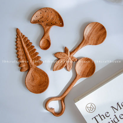 Collection of hand-carved leaf wooden spoons with unique botanical designs and natural wood grain